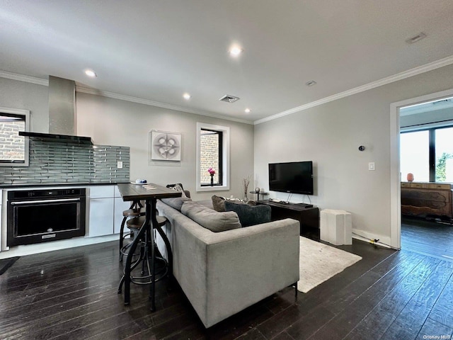 living room with ornamental molding and dark hardwood / wood-style floors