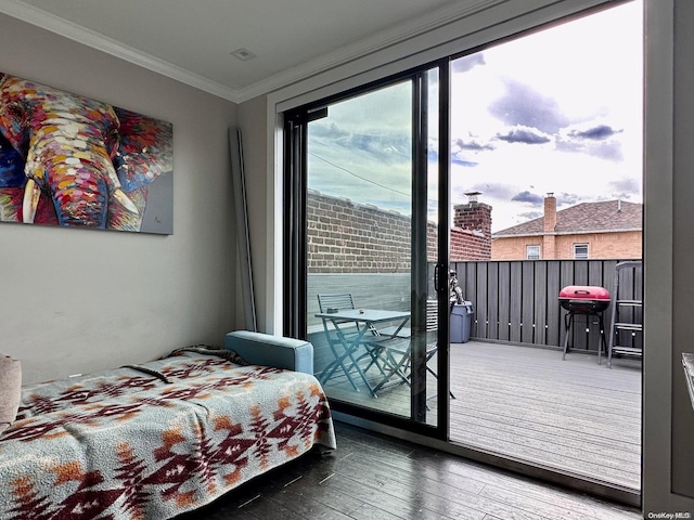 bedroom featuring access to exterior, wood-type flooring, and ornamental molding