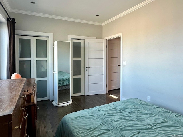 bedroom featuring ornamental molding, dark hardwood / wood-style flooring, and a closet