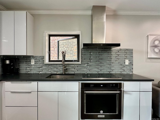 kitchen with sink, white cabinets, exhaust hood, black appliances, and crown molding