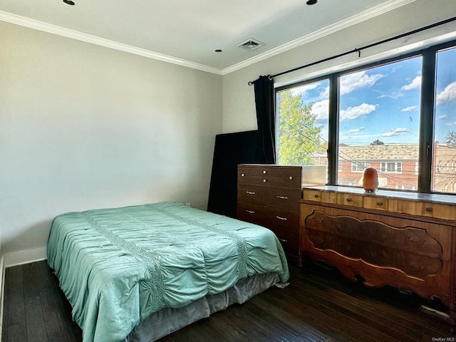 bedroom with crown molding and dark hardwood / wood-style floors