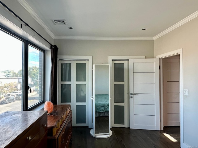 bedroom featuring ornamental molding and dark hardwood / wood-style floors