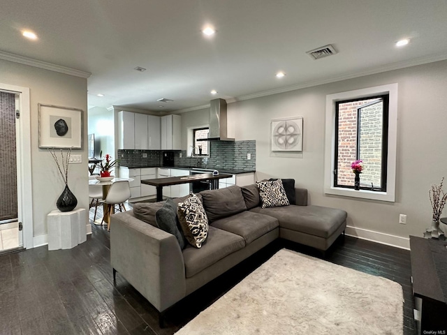 living room featuring dark hardwood / wood-style flooring and crown molding