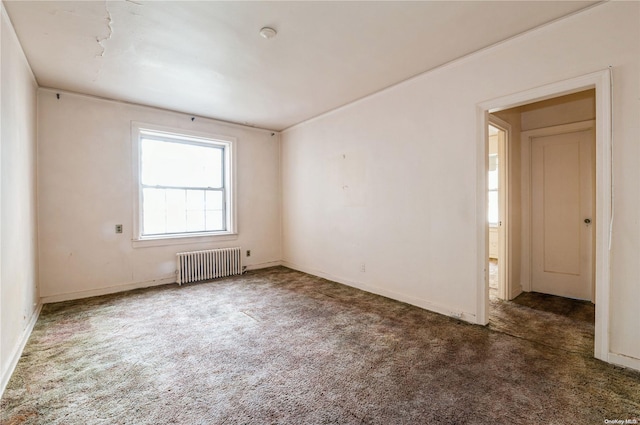 carpeted spare room with radiator heating unit