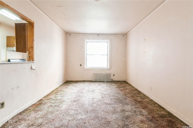 carpeted empty room with radiator heating unit