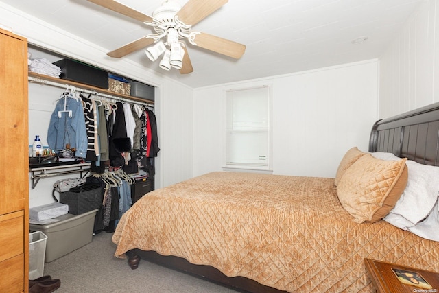 carpeted bedroom featuring ceiling fan and a closet