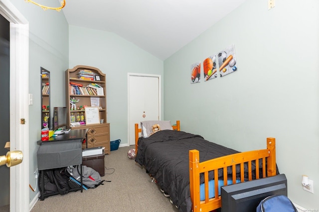 carpeted bedroom with lofted ceiling