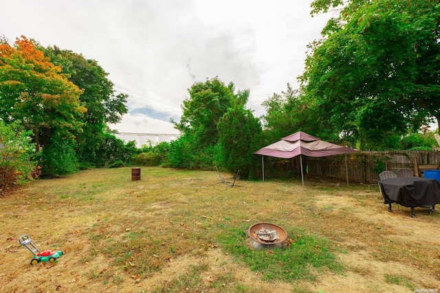 view of yard with an outdoor fire pit