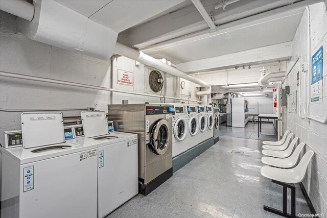 clothes washing area featuring washer and clothes dryer