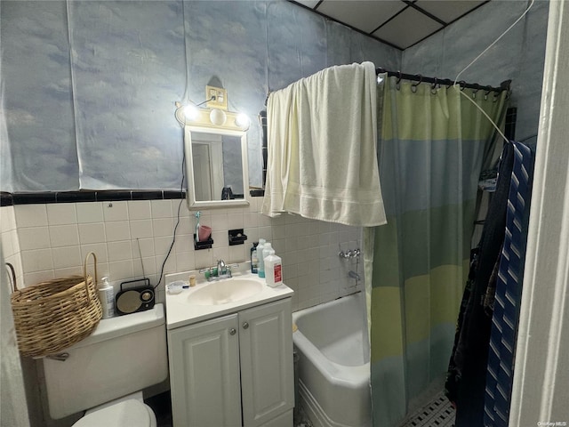 full bathroom with shower / tub combo, vanity, toilet, and tile walls