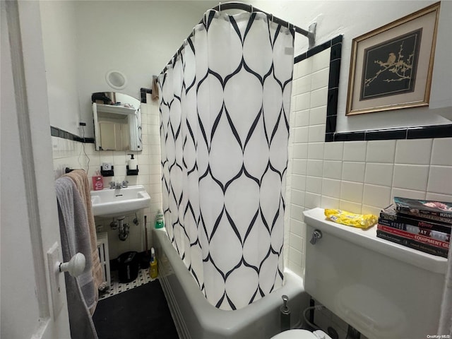 bathroom featuring shower / bath combo, tasteful backsplash, toilet, and tile walls