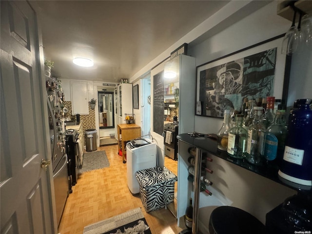 kitchen featuring white cabinets and light parquet floors