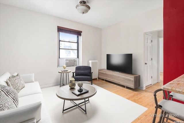 living room featuring radiator heating unit, cooling unit, and hardwood / wood-style flooring