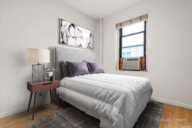 bedroom with hardwood / wood-style flooring