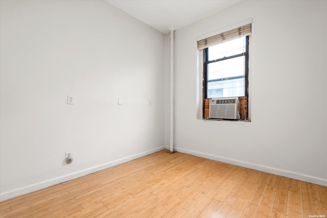 empty room with light hardwood / wood-style floors and cooling unit