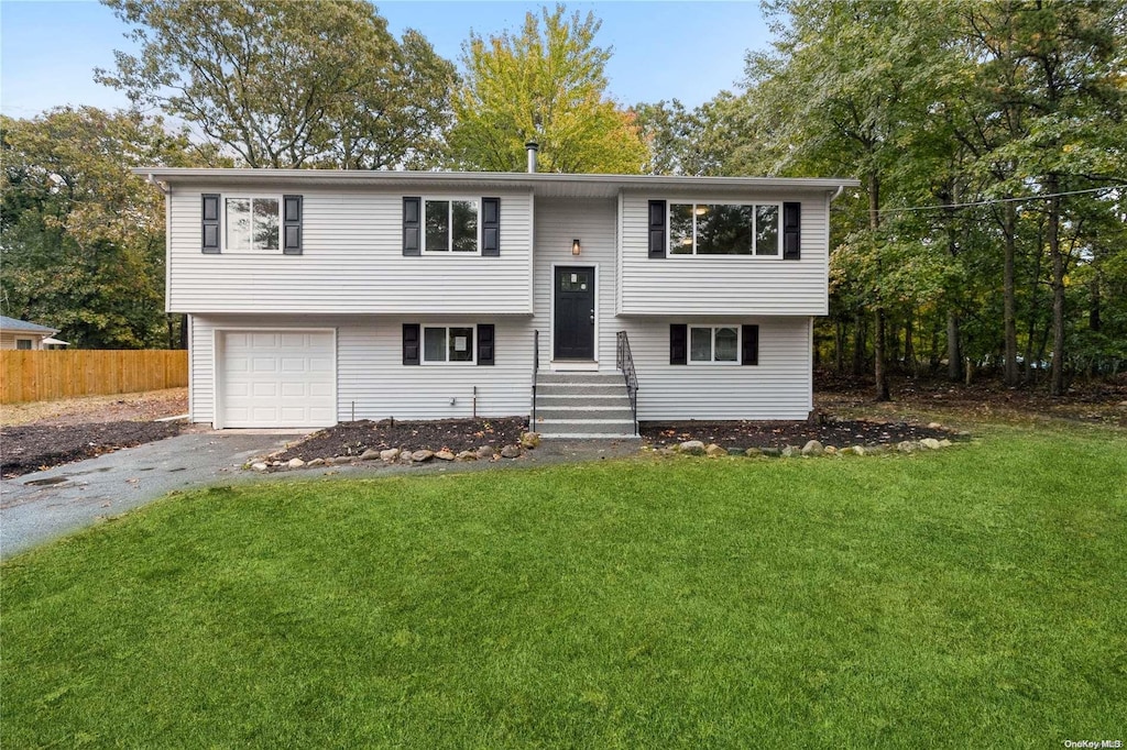 29 Wilson Ave, Middle Island, NY 11953 - raised ranch with driveway, an attached garage, and entry steps
