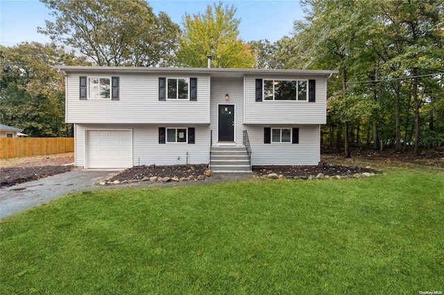 29 Wilson Ave, Middle Island, NY 11953 - raised ranch with driveway, an attached garage, and entry steps