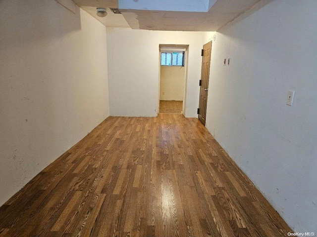 hallway with hardwood / wood-style floors