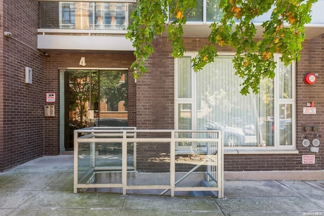 property entrance featuring a patio area and a balcony