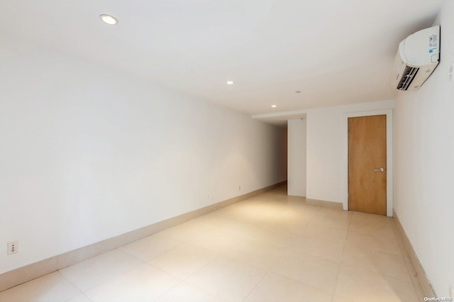 unfurnished room featuring an AC wall unit