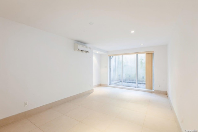 unfurnished room featuring an AC wall unit