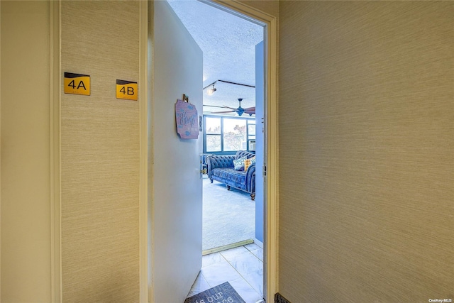 hallway with a textured ceiling