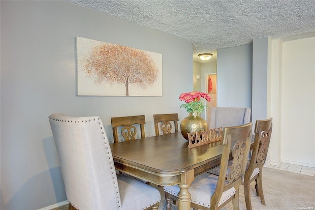 carpeted dining space with a textured ceiling