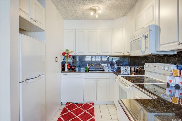 kitchen with white cabinetry, white appliances, and a textured ceiling