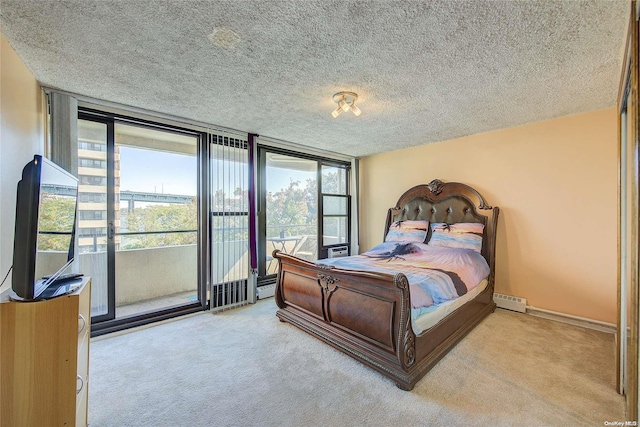 carpeted bedroom with a textured ceiling and expansive windows