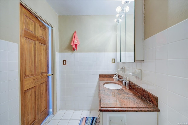 bathroom with tile patterned flooring, vanity, and tile walls