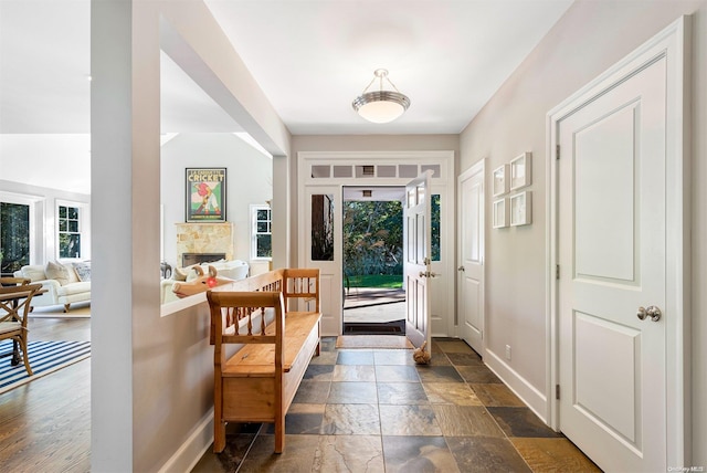 entryway with a fireplace and dark wood-type flooring