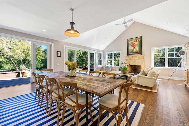 dining room featuring ceiling fan, dark wood-type flooring, and high vaulted ceiling