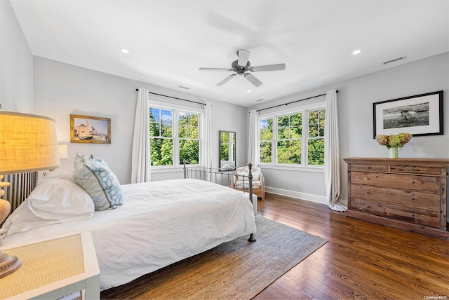 bedroom with ceiling fan and dark hardwood / wood-style floors