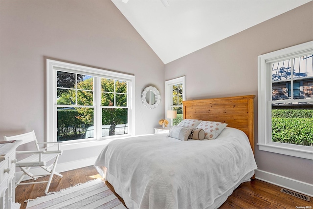 bedroom with dark hardwood / wood-style flooring and high vaulted ceiling