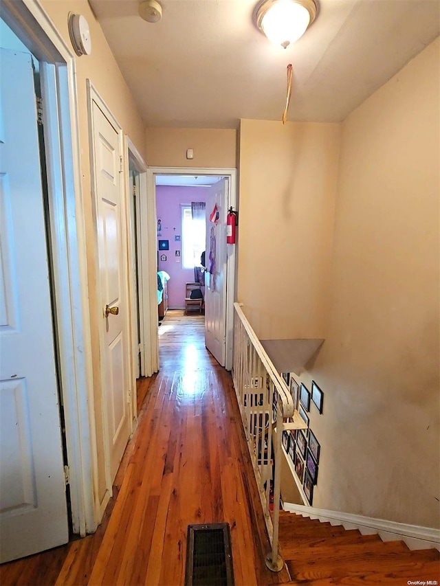 corridor with hardwood / wood-style floors