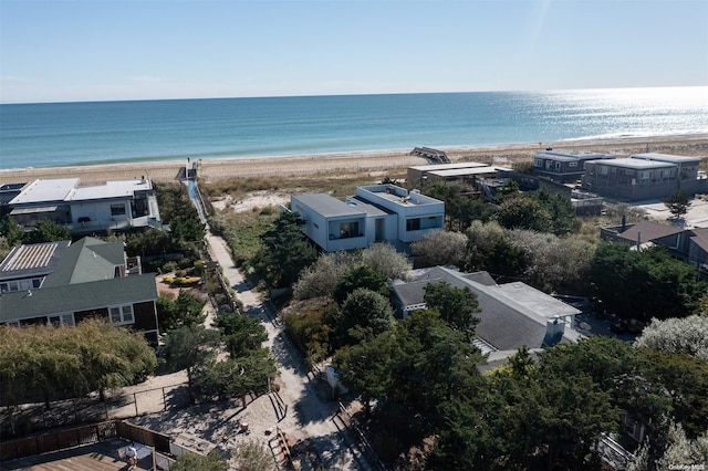 drone / aerial view with a water view and a beach view