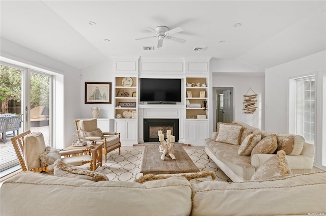 living room featuring ceiling fan and lofted ceiling