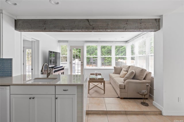 living room featuring sink and light tile patterned floors