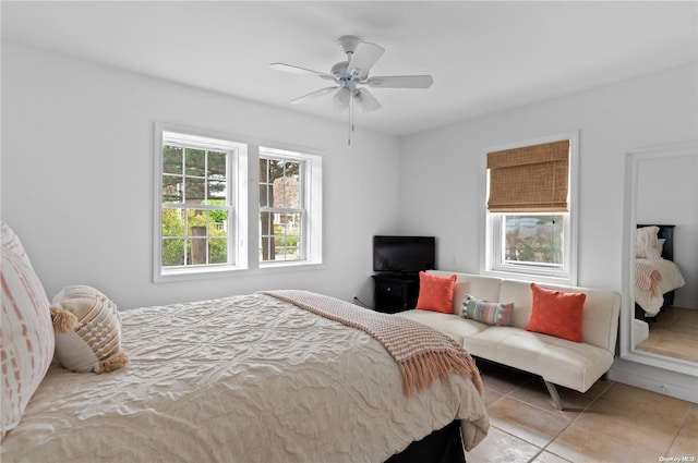 tiled bedroom featuring ceiling fan