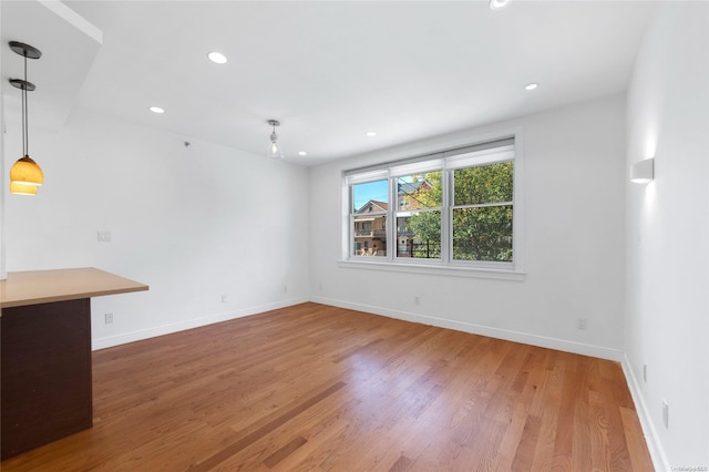 unfurnished living room featuring hardwood / wood-style flooring