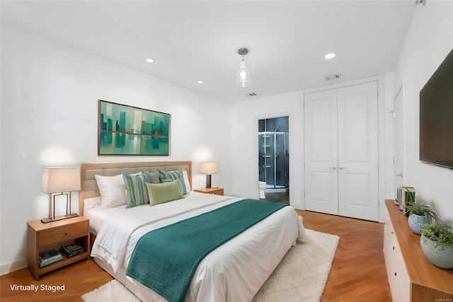 bedroom with recessed lighting, visible vents, light wood-style floors, and a closet