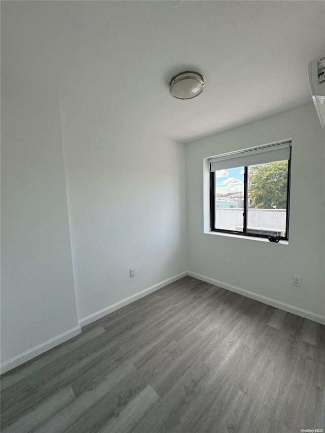 empty room with dark hardwood / wood-style floors