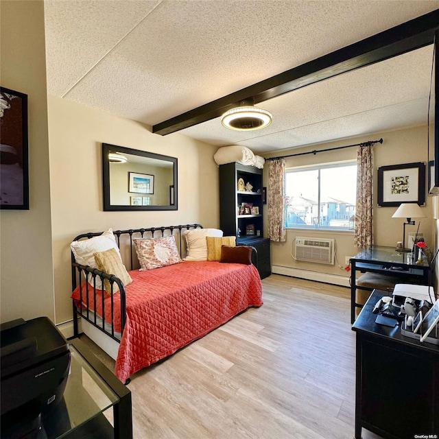 living room featuring hardwood / wood-style floors, a baseboard heating unit, a textured ceiling, beam ceiling, and a wall unit AC