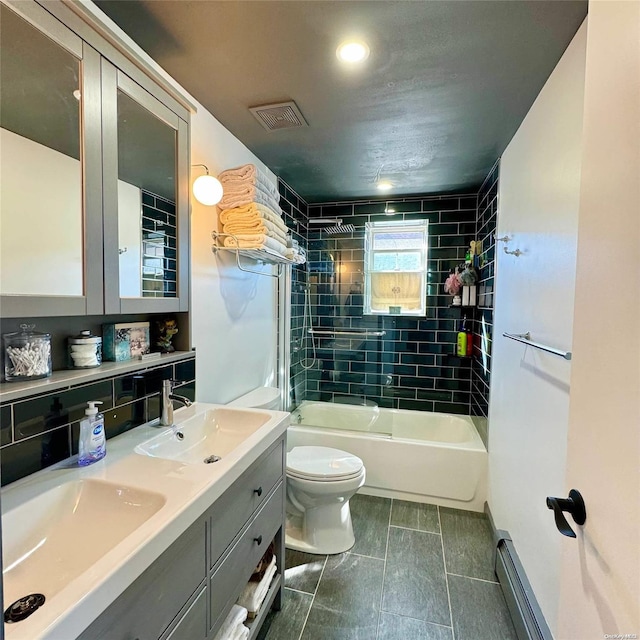 full bathroom with vanity, toilet, and tiled shower / bath