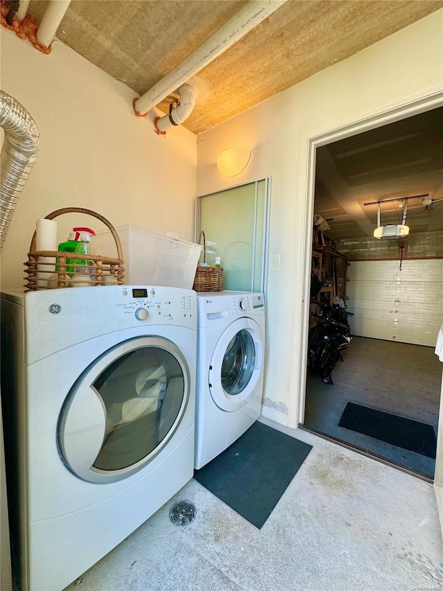 clothes washing area with washing machine and dryer