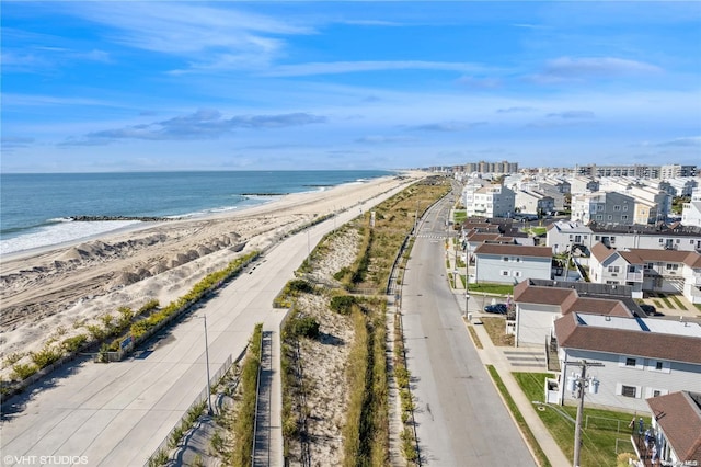 aerial view with a water view and a beach view