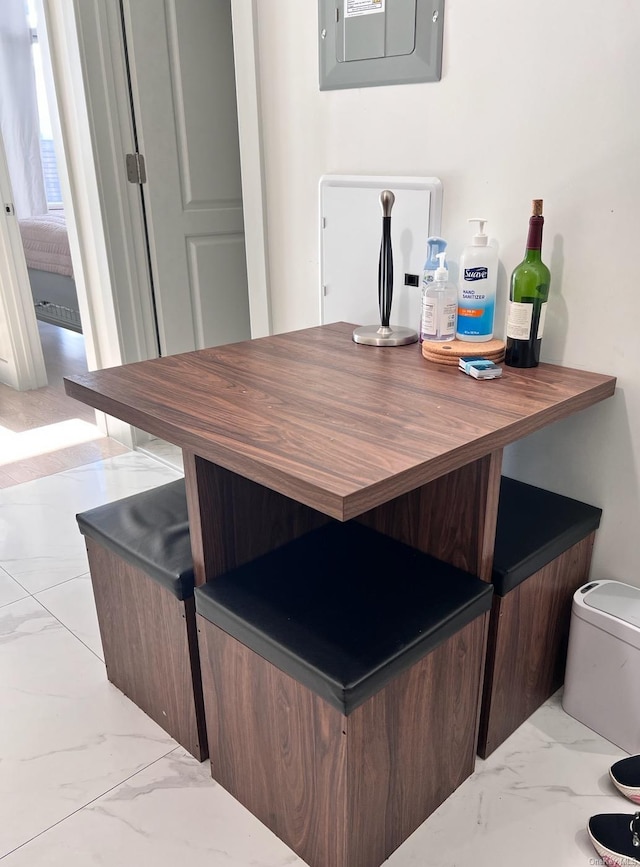 bar featuring electric panel and gray cabinetry