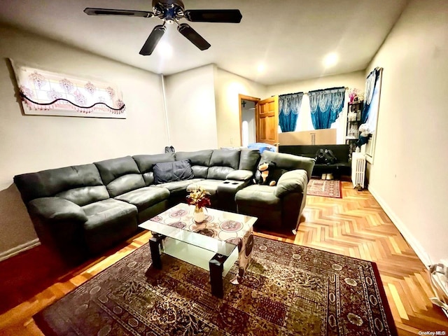 living room featuring ceiling fan, radiator heating unit, and parquet floors