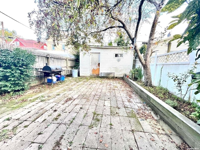 view of patio / terrace featuring area for grilling and an outbuilding