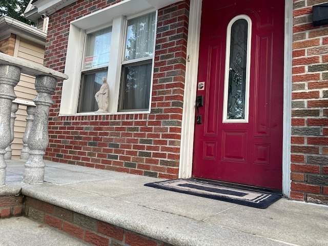 property entrance featuring brick siding